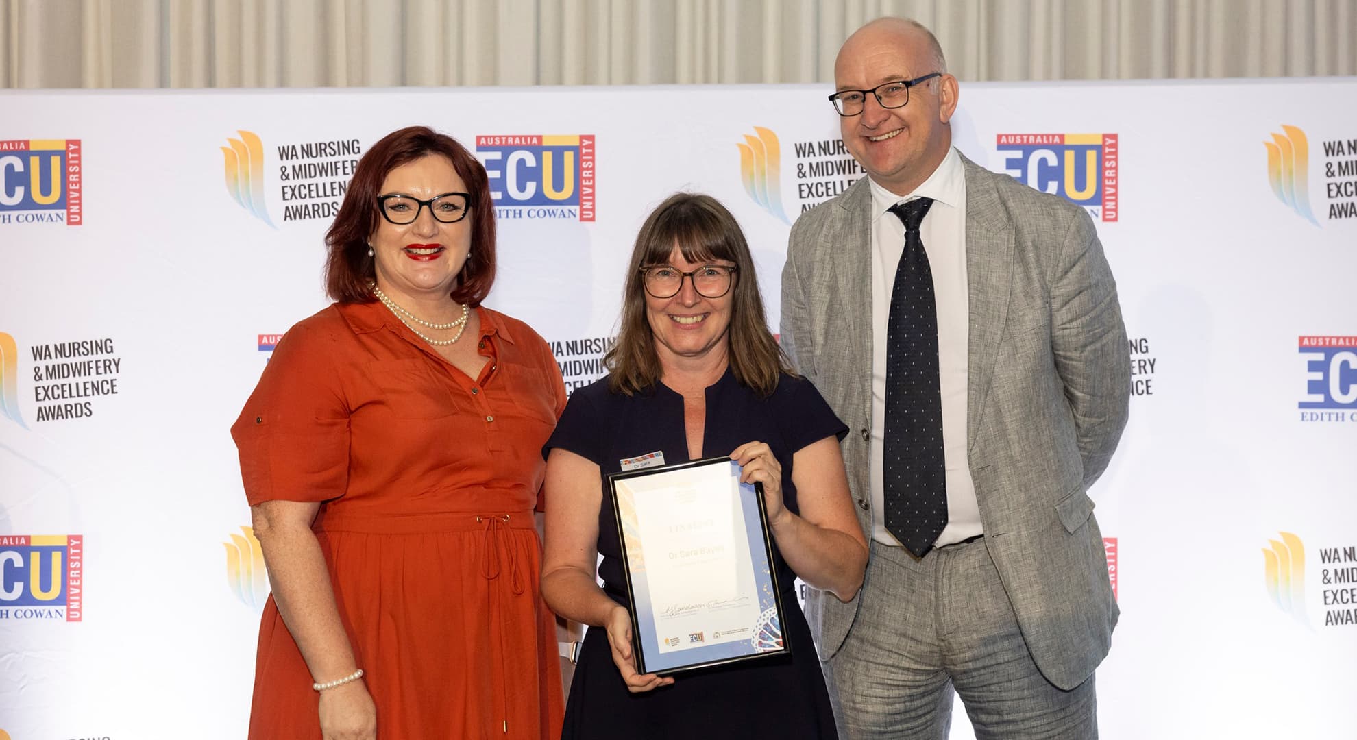 Professor Sara Bayes holds a framed certificate at the 2024 WA Nursing and Midwifery Awards.