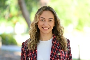 Tilly Casey standing outside with a red blazer on