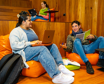 Students collaborate on the staircase workspace at ECU Library Joondalup.