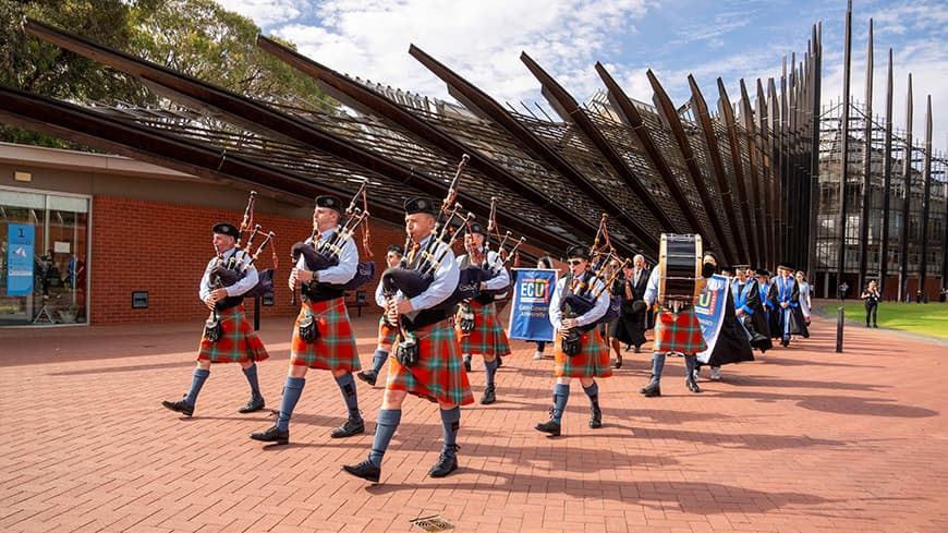 Pipe Band walking through campus