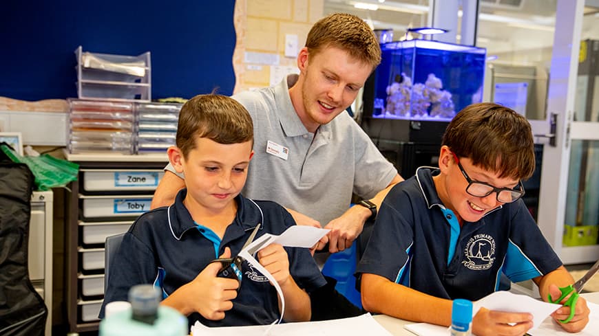 Young male teacher with two students