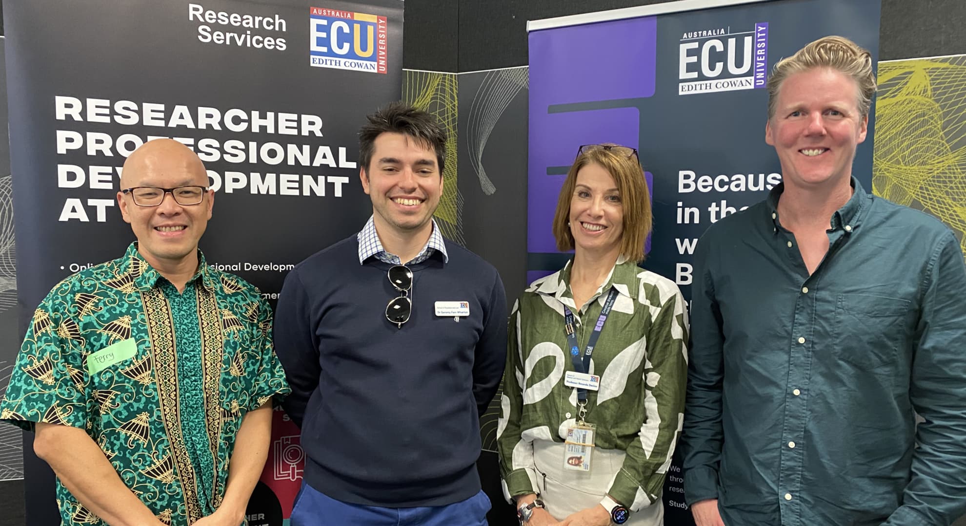 Four ECU researchers stand together at a workshop.