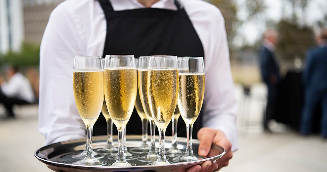 Waiter holding tray of champagne