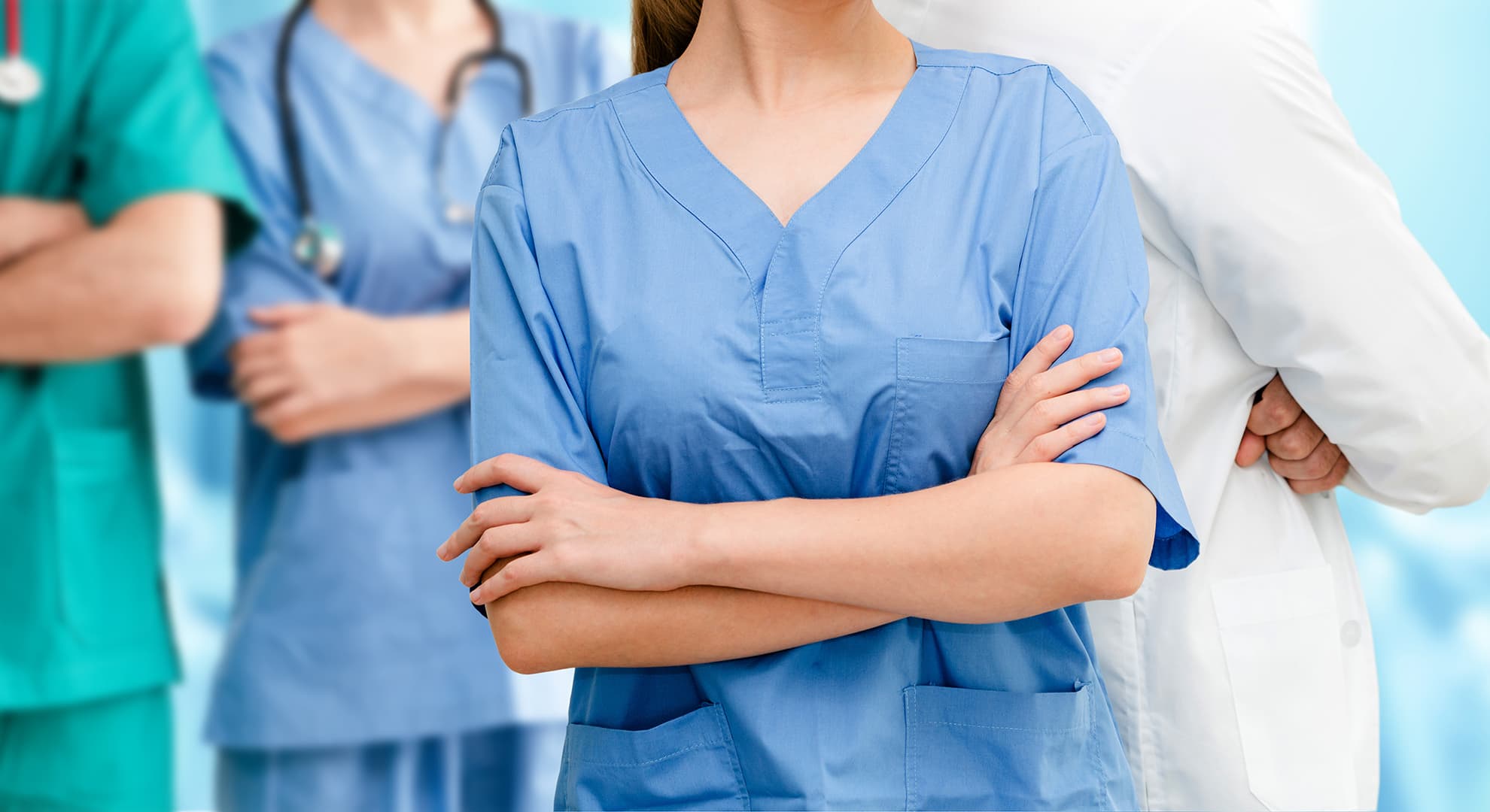 Chest height view of three nurses and a doctor.