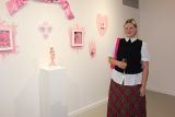 Photo of artist next to her porcelain artworks