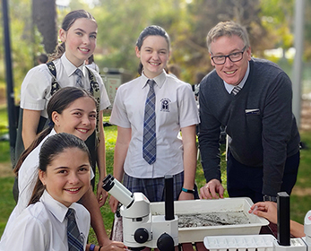 Mater Dei College students and teacher conducting a science experiment.. 