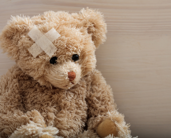 teddy bear with a Band-Aid on its ear