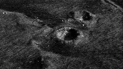 Black and white photo of rain droplets in sand