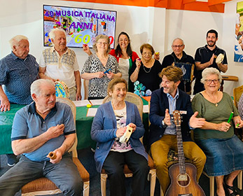 SAGE Researchers interacting and singing with elderly participants.