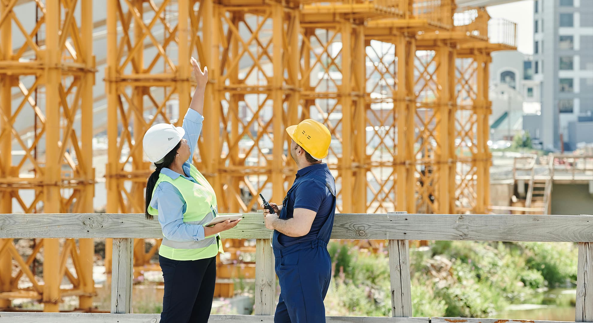 Man and woman standing at construction site.