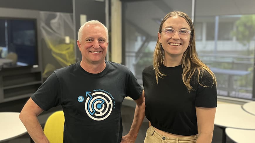 A CSIRO facilitator and ECU PhD candidate stand inside a classroom.