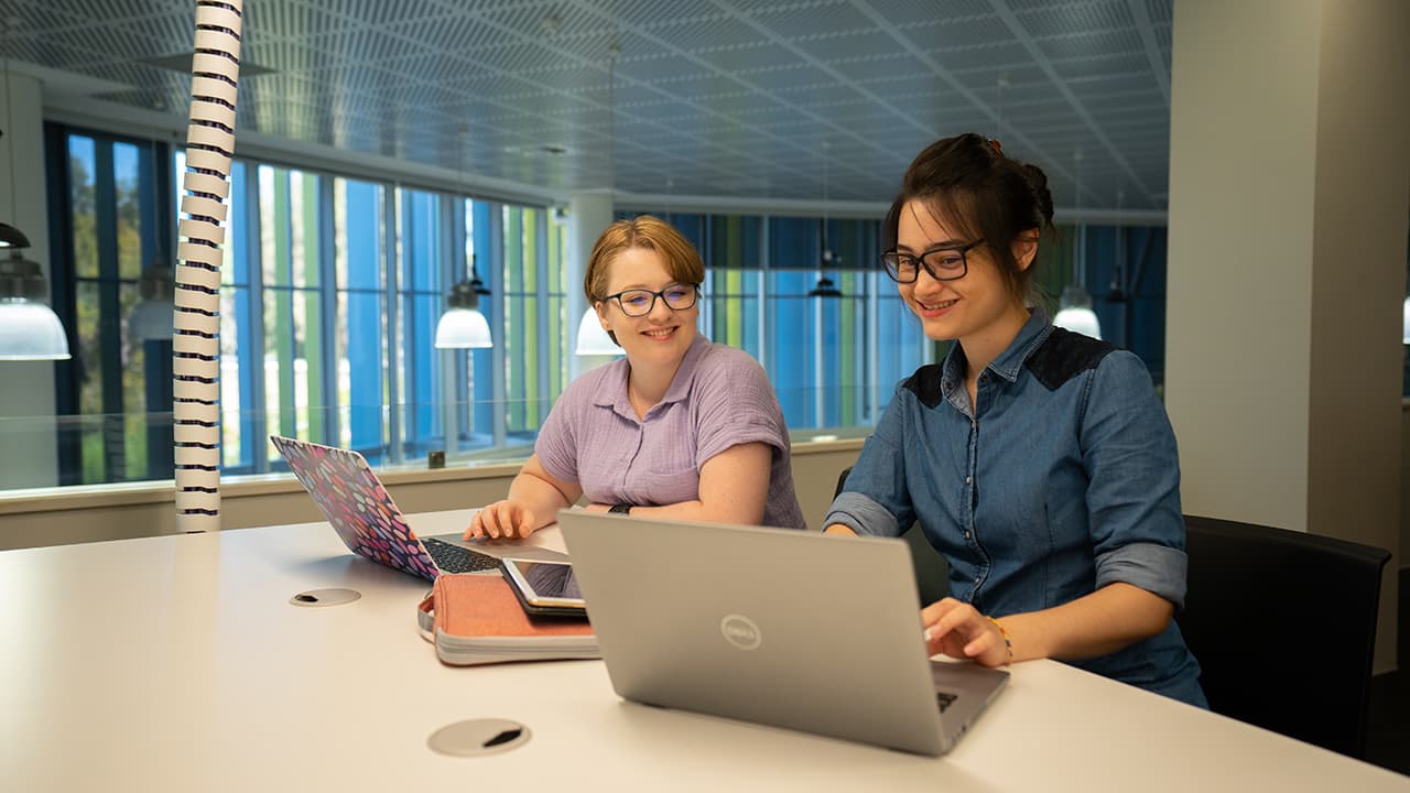 two students studying in a library