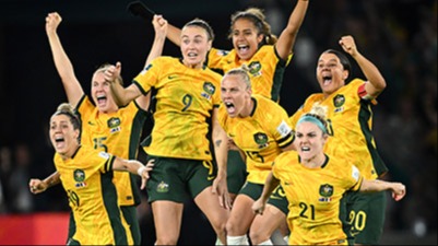 Photograph of a female soccer team jumping in celebration