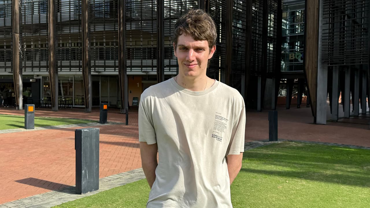 Young man standing on campus at ECU