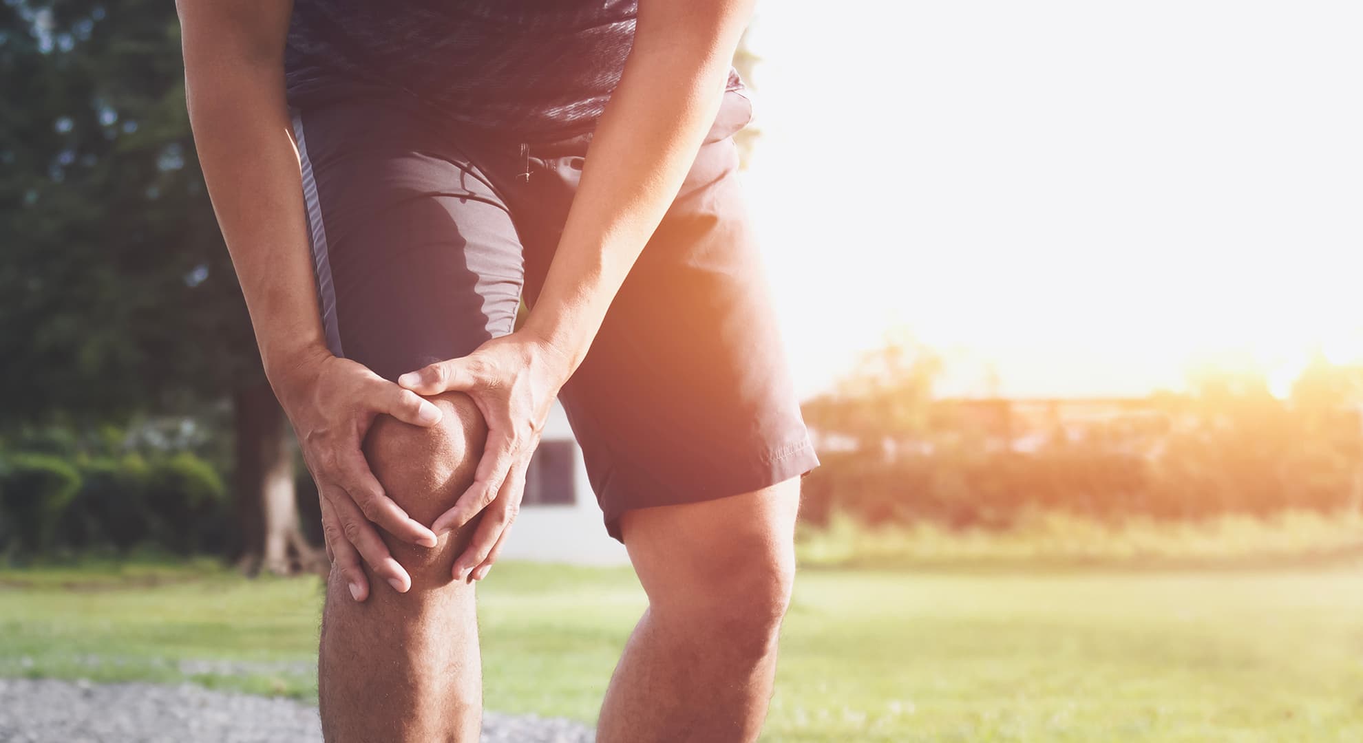 Man holding injured knee.