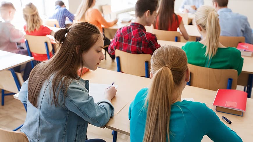 Students in a classroom doing homework.