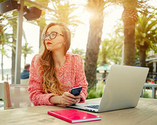 girl with a computer outdoors