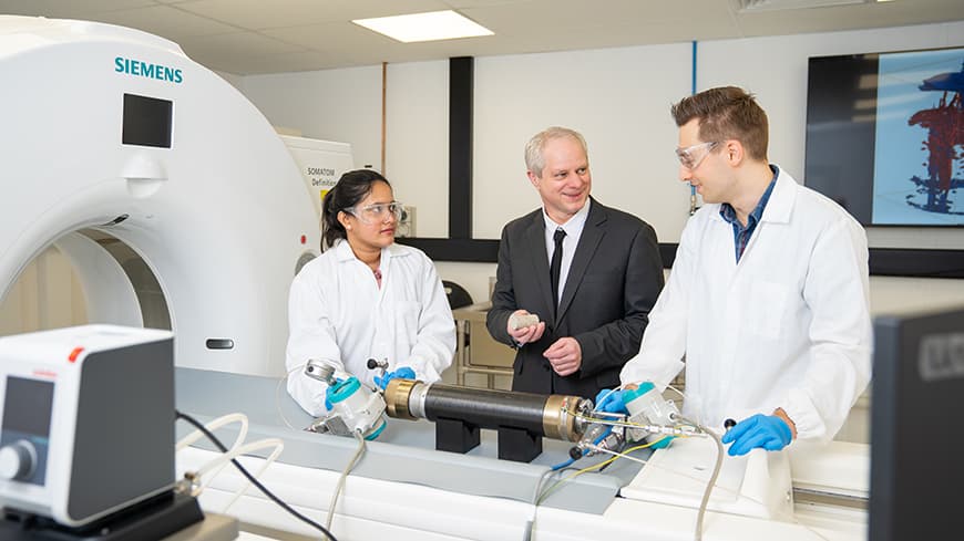 Three people in an engineering laboratory