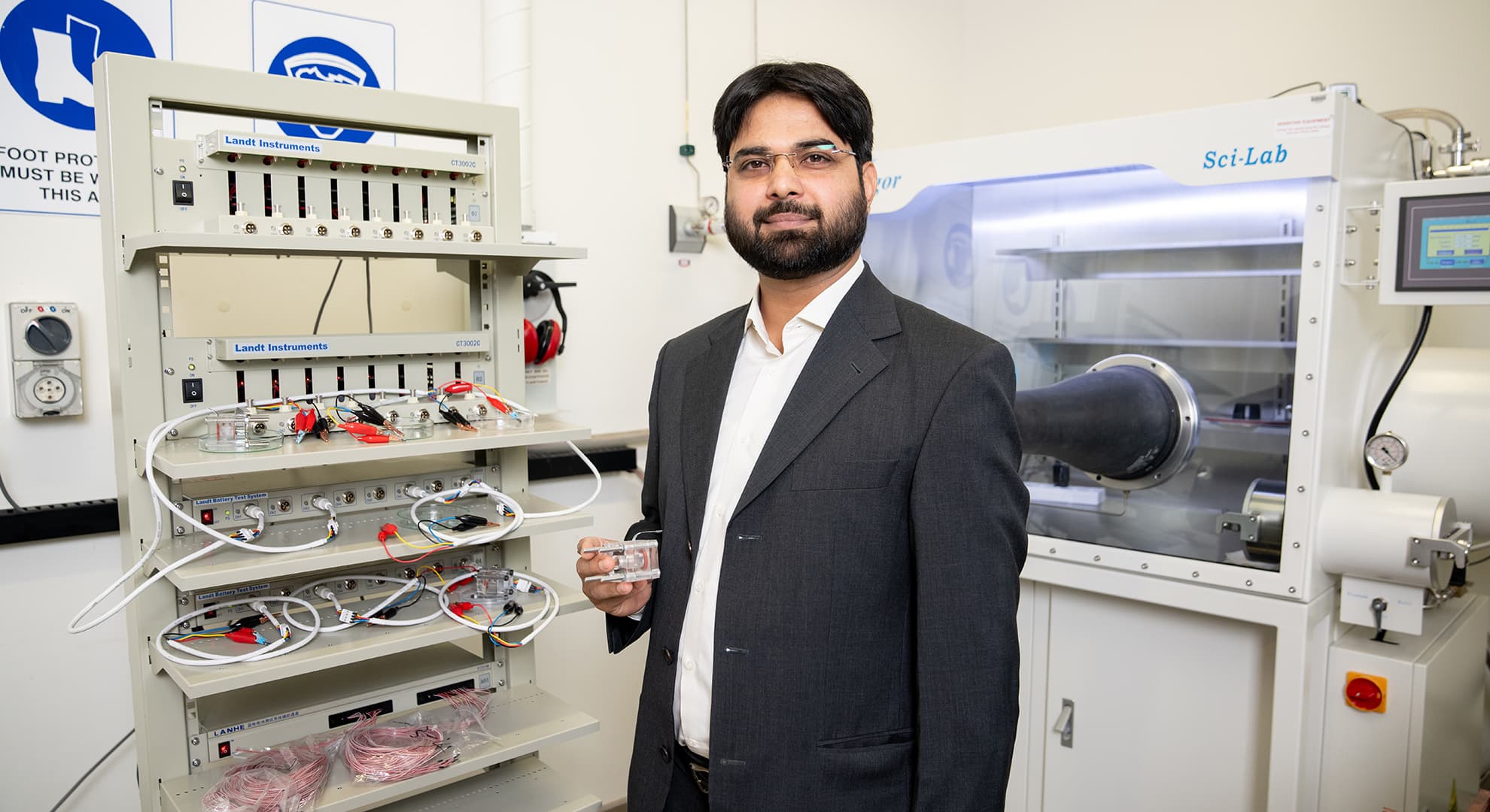 Dr Muhammad Rizwan Azhar holds a zinc-air battery prototype.