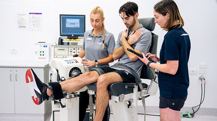 Students using equipment in a university sports science laboratory