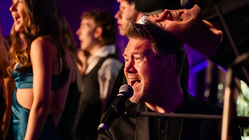 Eddie Perfect on stage with WAAPA music students