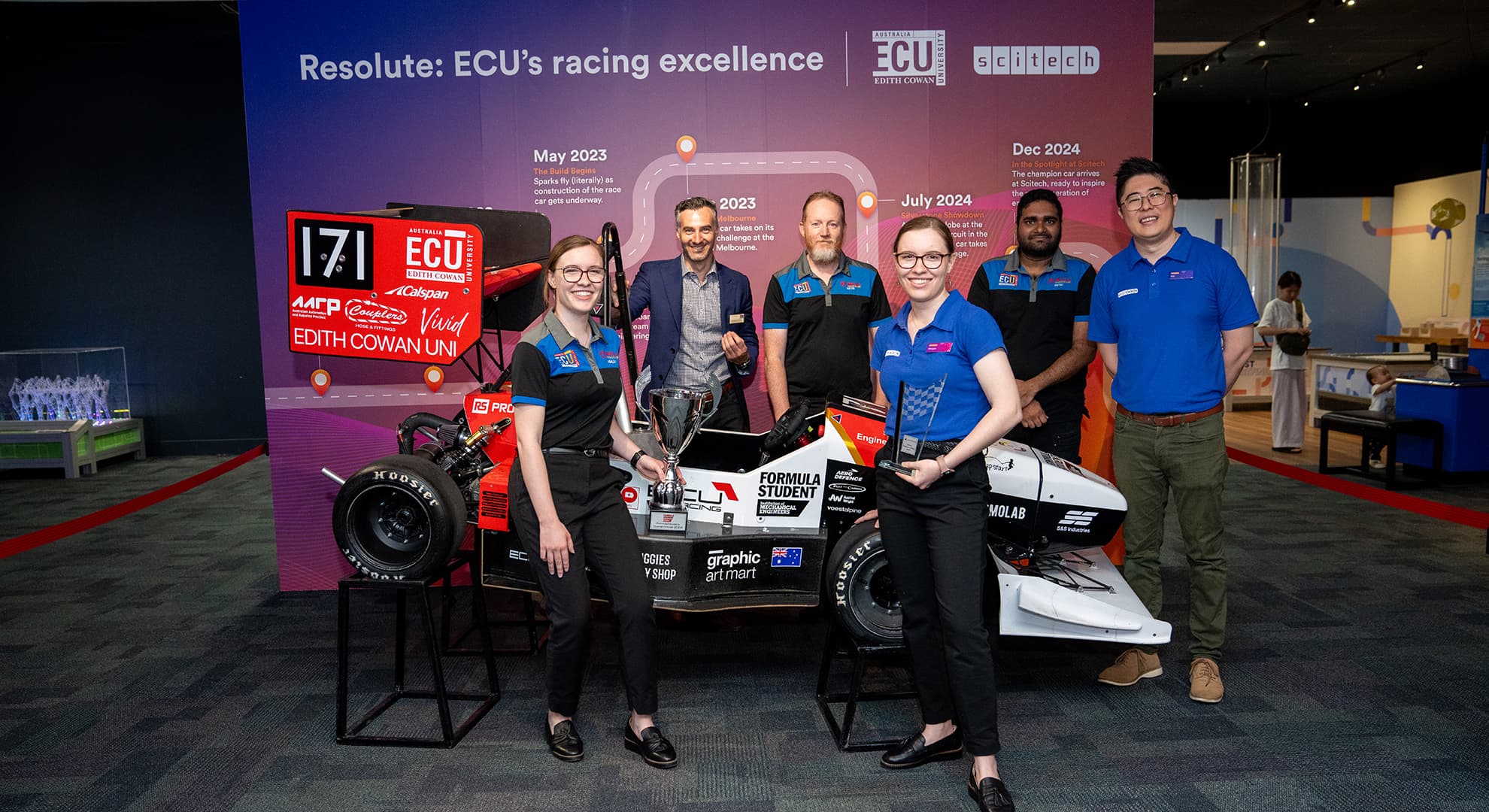 ECU Racing car on display at Scitech, with ECU students and staff