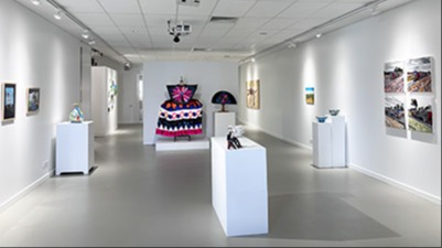 Painting and sculptural artworks on display in exhibition gallery