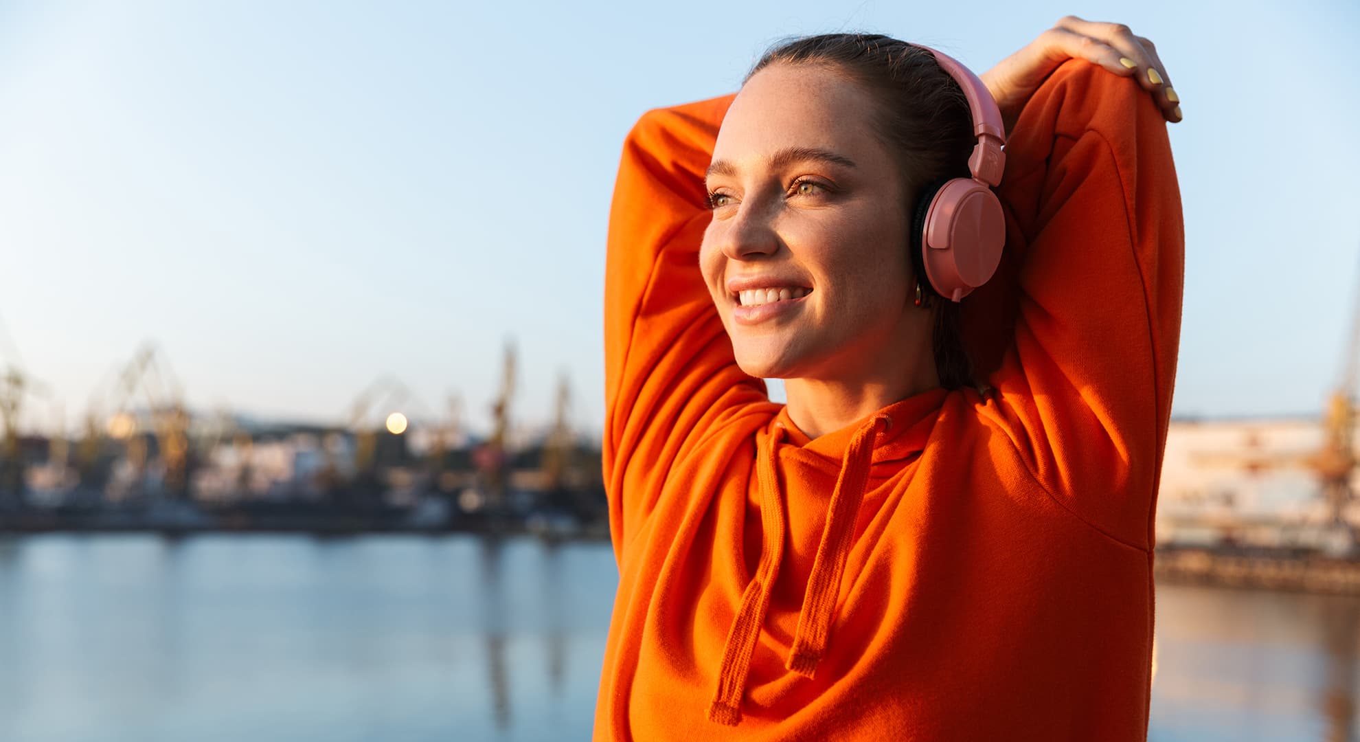 Woman with headphones stretching