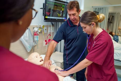 ECU nursing student and lecturer checking the heart rate of a figure.