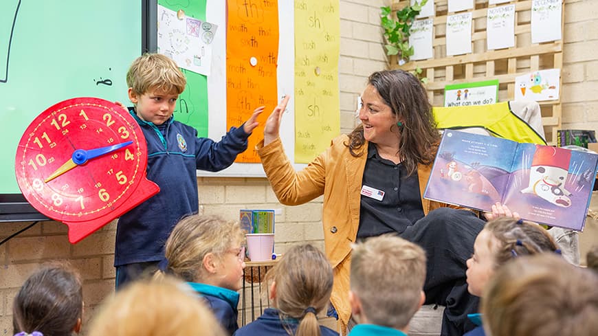 Young student learning to tell the time