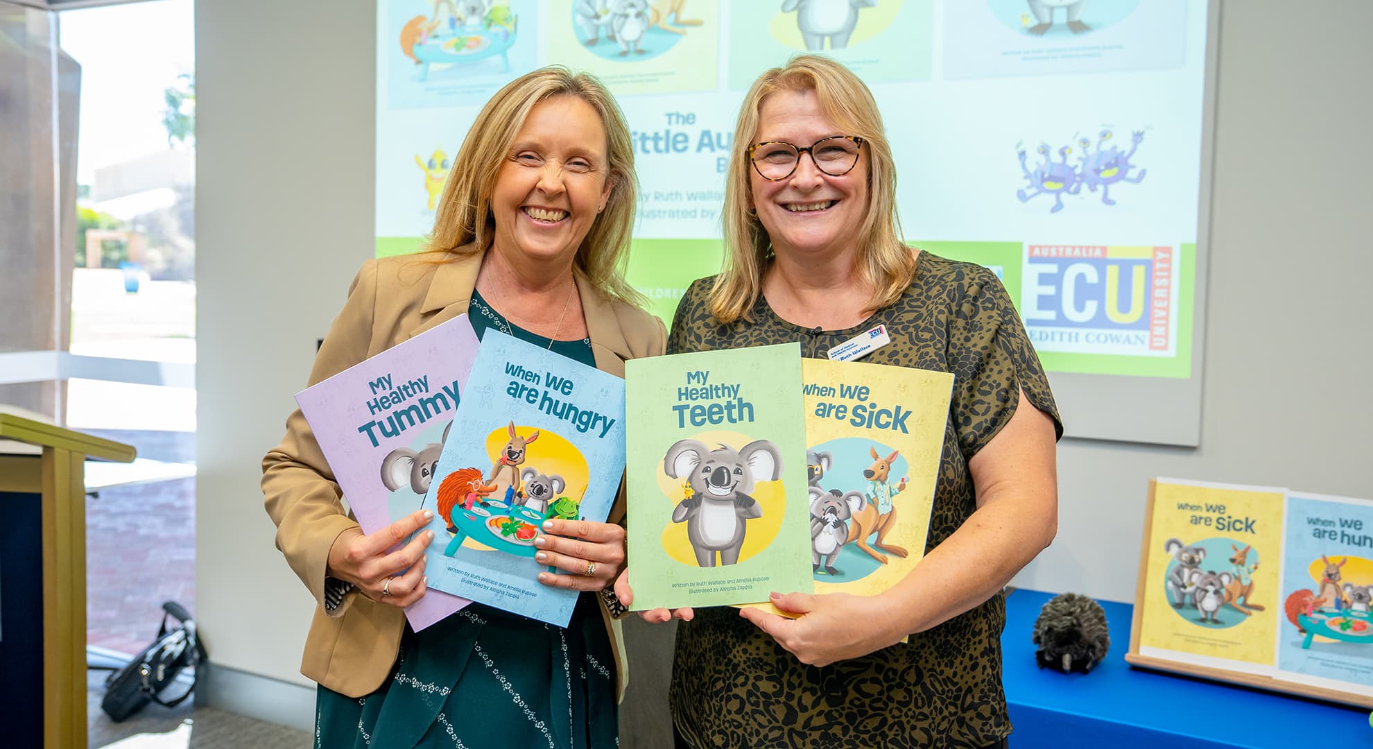 Dr Amelia Ruscoe and Dr Ruth Wallace holding The Little Aussie Bugs books.