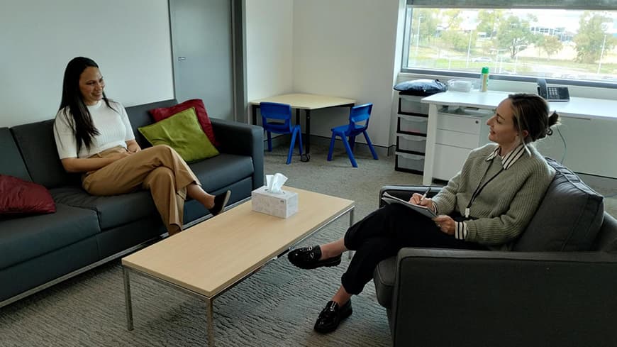 ECU student Danielle Hayman sits in a counselling room and chats to a patient.