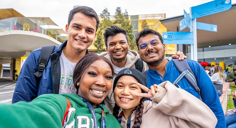 International students smiling at camera