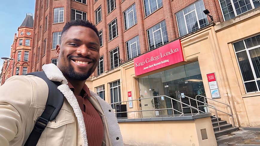 Dr Gideon Johnson takes a selfie outside King's College London.