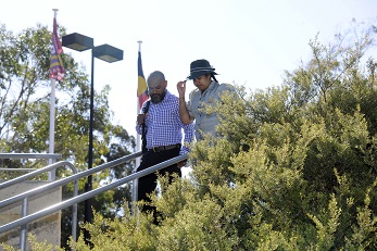 Staff member walking on campus with his daughter