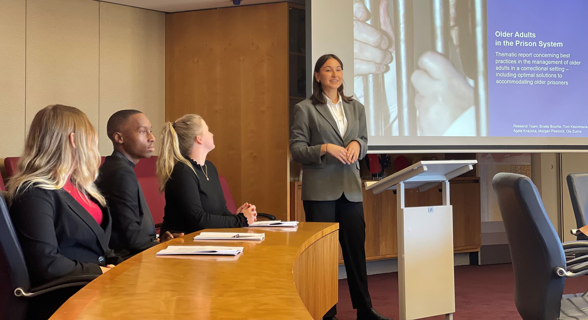 Female student presenting to a group of others.