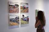 Female looking at artworks on exhibition wall