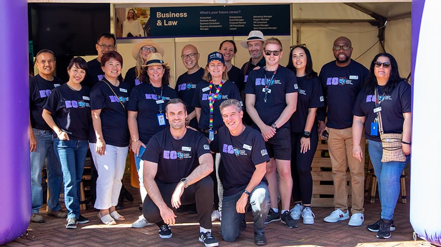 SBL Lecturers and researchers under purple banner.