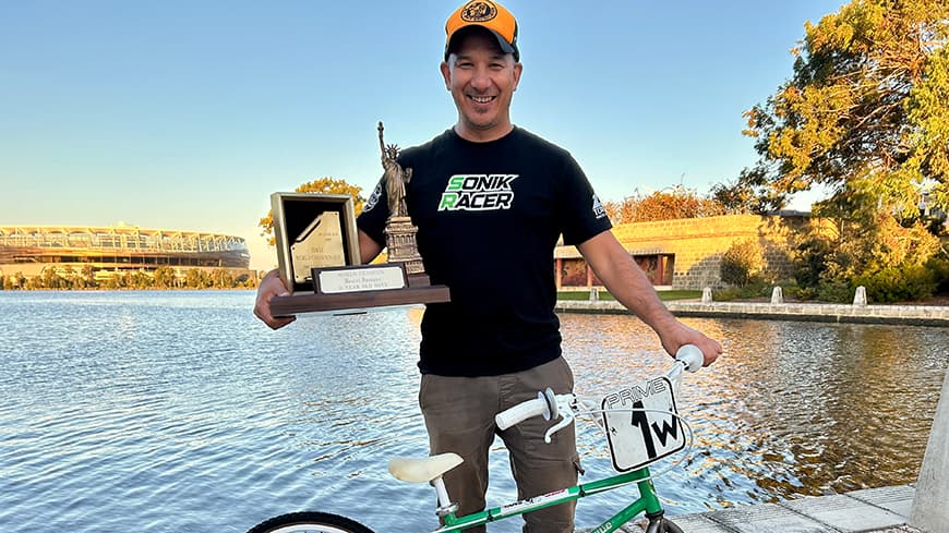 Daniel Sprague holding his first BMX World Championship award and bike.