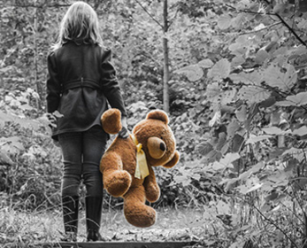 girl holding a teady bear