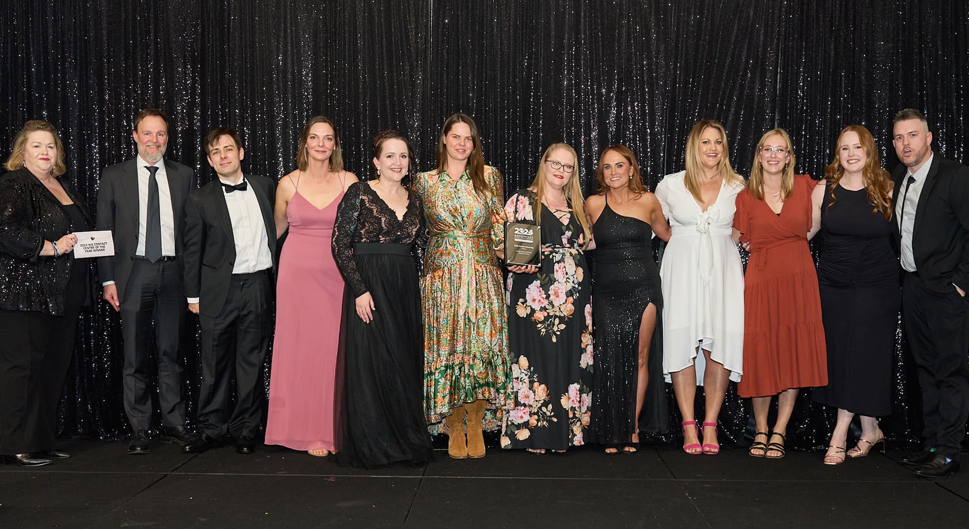 ECU's Communications Centre Team together on stage at the 2024 Auscontact Awards holding awards