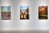 Photographic images hanging on exhibition walls