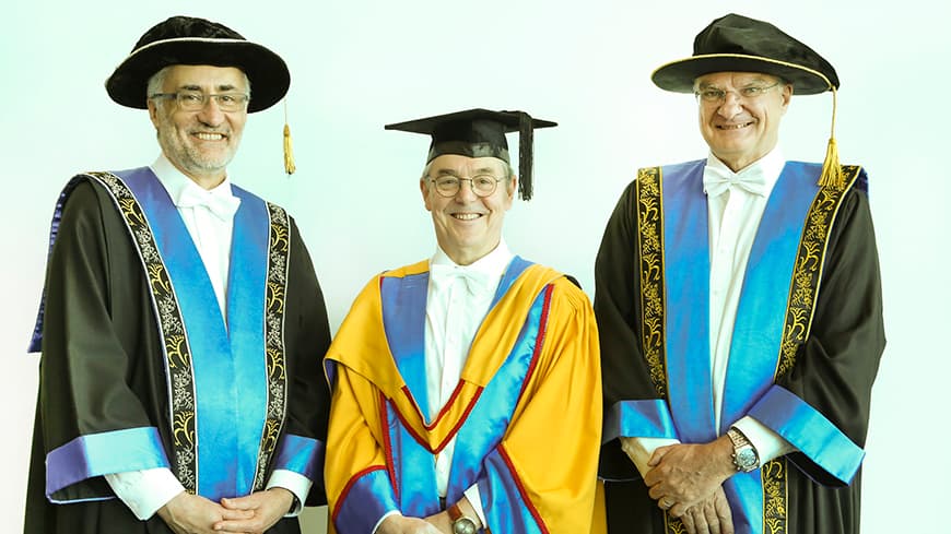 ECU Interim Vice-Chancellor Professor Arshad Omari, Emeritus Professor Steve Chapman CBE and ECU Deputy Chancellor Robert Radley pose for the camera in formal regalia and caps for the graduation ceremony.