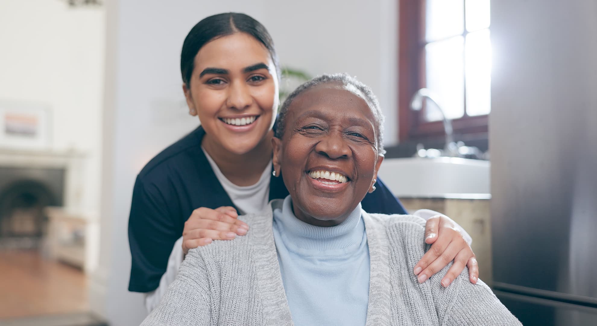 Smiling older woman and healthcare worker.