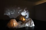 Sculpture and projected artworks on display in gallery exhibition