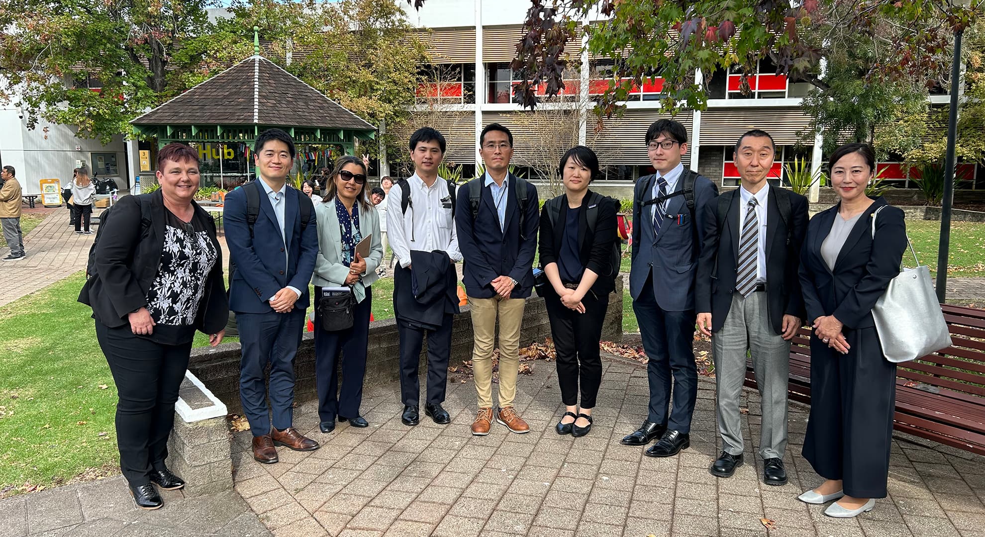 A delegation of Japanese journalists stadning outdoors on the Mount Lawley campus.