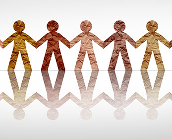 Paper cut outs of human figure all joined together as if they are attached or holding hands