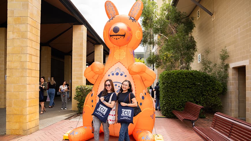 Students posing in front of giant inflatable Kangaroo