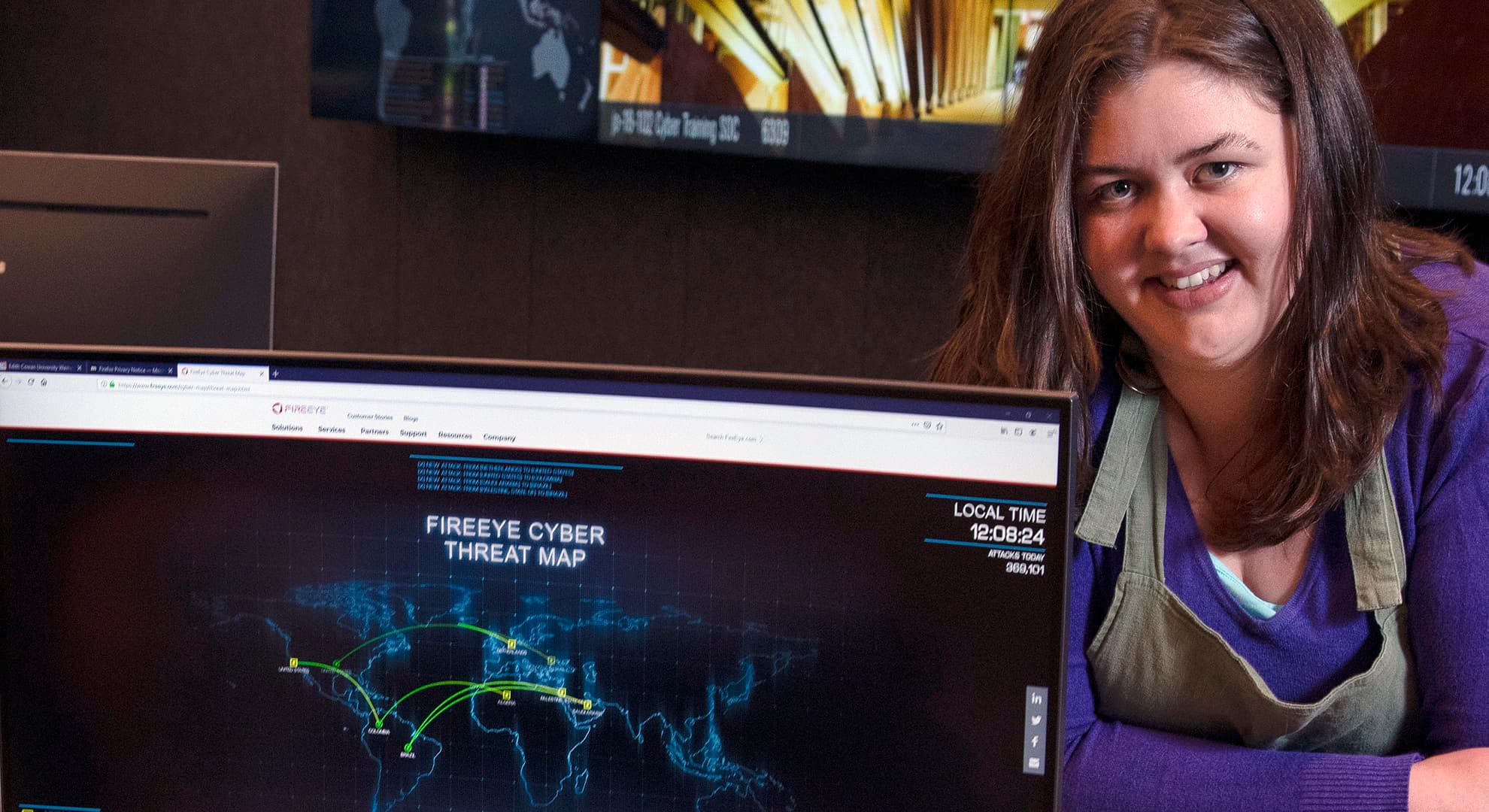 Hannah Rice standing behind a computer screen.