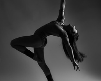 A dancer strikes a pose against a dark background.